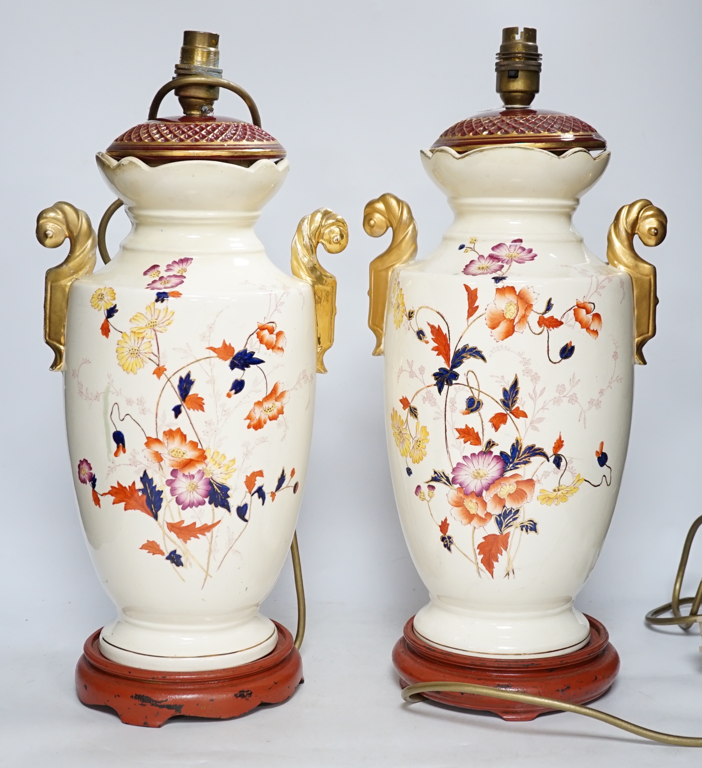A pair of early 20th century vases mounted as table lamps, hand painted with flowers, 45cm high